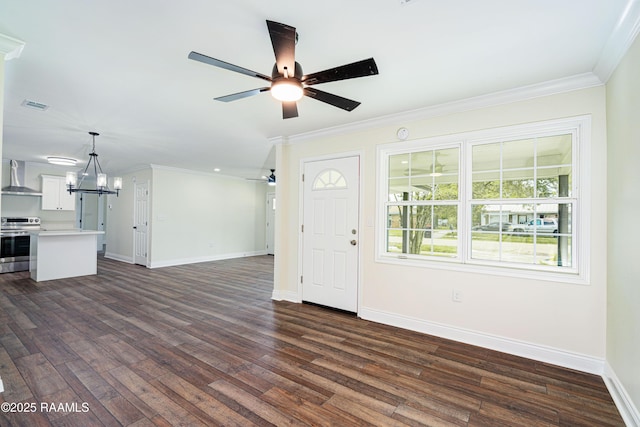 906 Priscilla Ln, Lafayette, LA 70501 - unfurnished living room featuring dark wood-type flooring, baseboards, and ceiling fan with notable chandelier