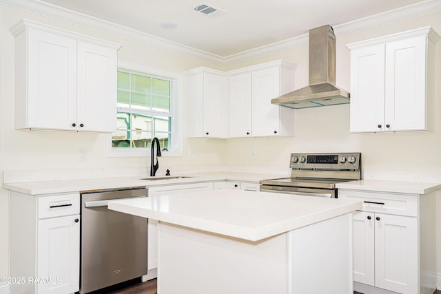 906 Priscilla Ln, Lafayette, LA 70501 - kitchen with wall chimney exhaust hood, stainless steel appliances, a sink, and white cabinetry