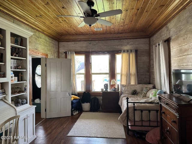 interior space with dark wood-style flooring, a ceiling fan, ornamental molding, and wood ceiling