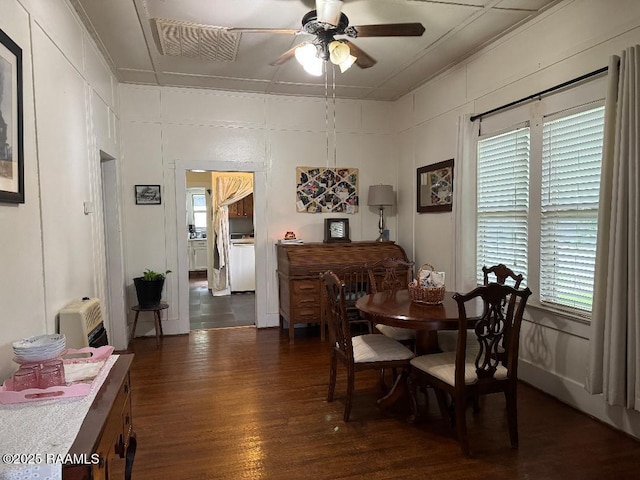dining area with dark wood-type flooring and ceiling fan