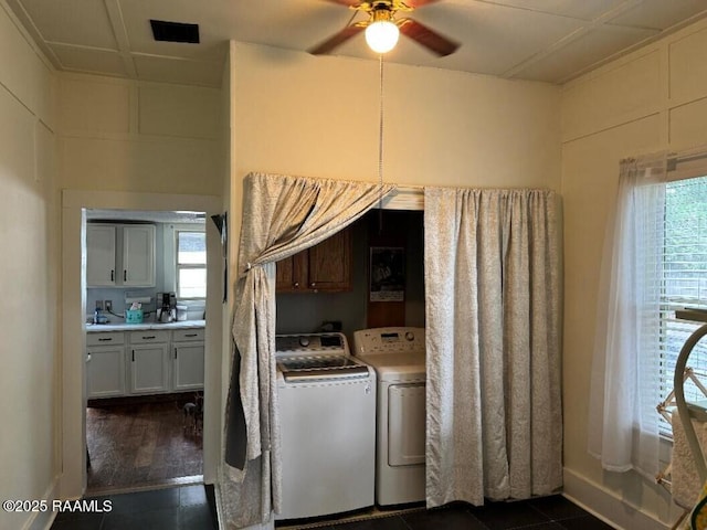 washroom featuring plenty of natural light, washer and clothes dryer, cabinet space, and a ceiling fan