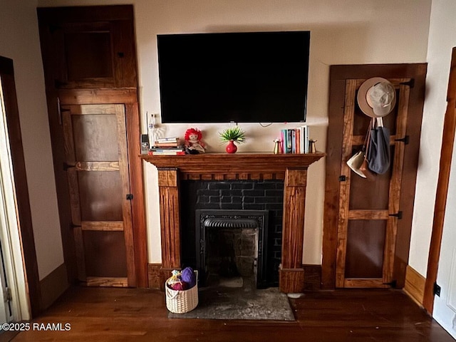 interior details featuring a fireplace and wood finished floors