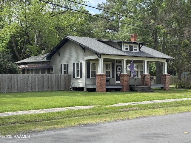 craftsman inspired home featuring a shingled roof, fence, covered porch, and a chimney