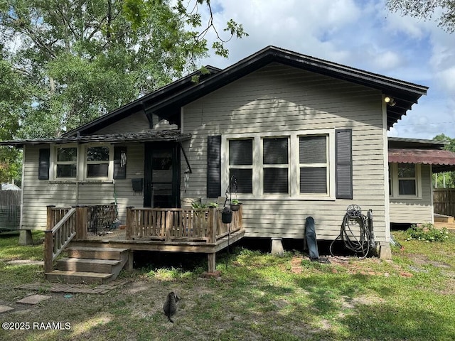 view of front facade featuring a deck and a front yard