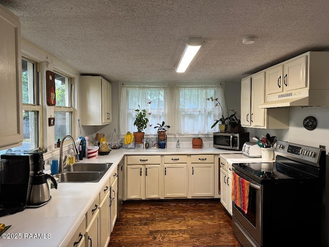 807 N Polk St, Rayne, LA 70578 - kitchen with a textured ceiling, appliances with stainless steel finishes, dark wood-style floors, and a sink