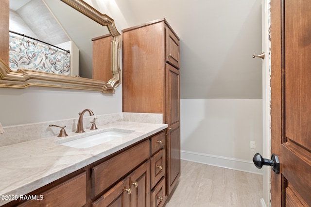 full bathroom featuring vaulted ceiling, vanity, wood finished floors, and a shower with curtain
