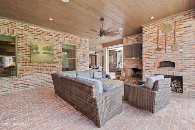 view of patio / terrace featuring an outdoor living space with a fireplace and ceiling fan