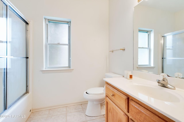 full bathroom featuring baseboards, enclosed tub / shower combo, toilet, tile patterned floors, and vanity