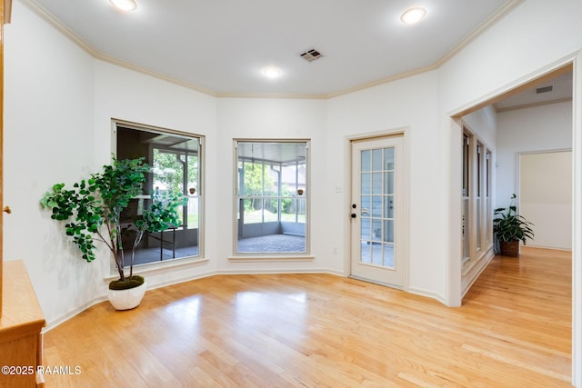 interior space with visible vents, light wood-type flooring, crown molding, and recessed lighting