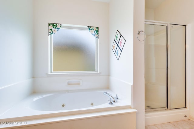 full bathroom featuring a shower stall and a whirlpool tub