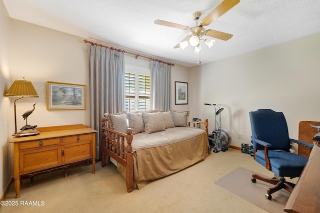 bedroom featuring light colored carpet, a ceiling fan, and baseboards