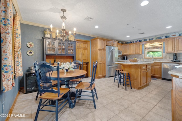 dining area featuring crown molding, a notable chandelier, a textured ceiling, recessed lighting, and baseboards