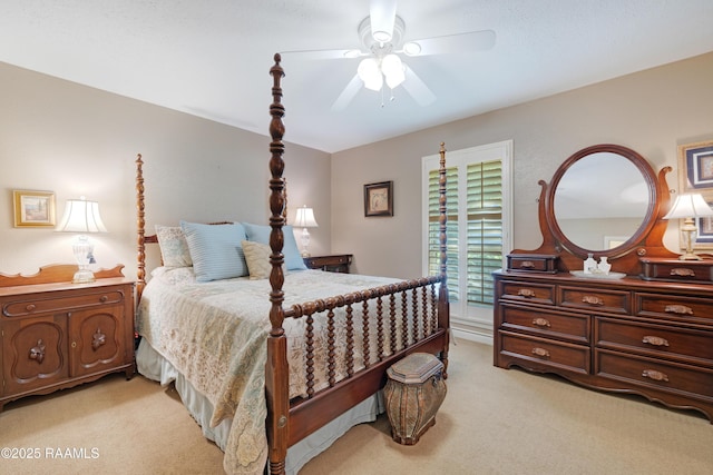 bedroom featuring ceiling fan and light carpet