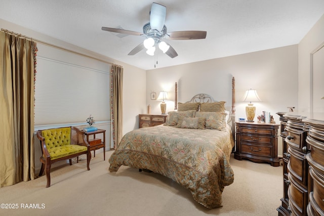 bedroom featuring ceiling fan and light carpet