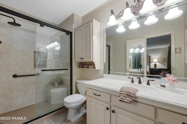 full bath with crown molding, a shower stall, vanity, tile patterned floors, and toilet