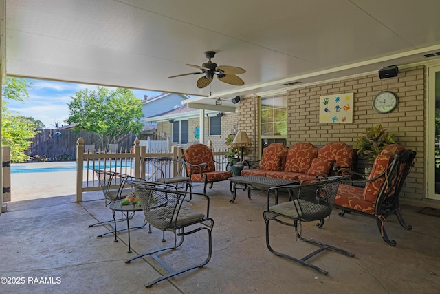 view of patio featuring fence, a fenced in pool, a ceiling fan, an outdoor living space, and visible vents