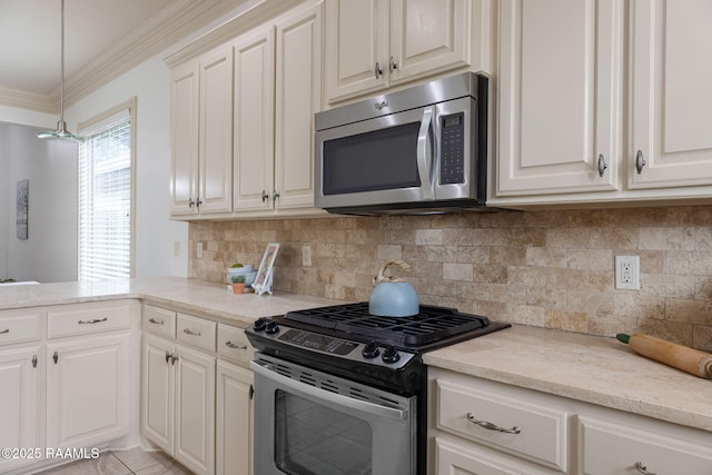 313 Summerland Key Ln, Lafayette, LA 70508 - kitchen featuring crown molding, decorative backsplash, appliances with stainless steel finishes, and hanging light fixtures