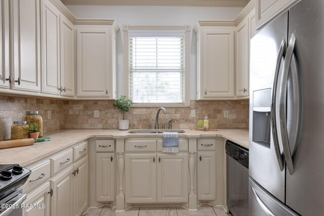 313 Summerland Key Ln, Lafayette, LA 70508 - kitchen with appliances with stainless steel finishes, tasteful backsplash, a sink, light countertops, and light tile patterned flooring