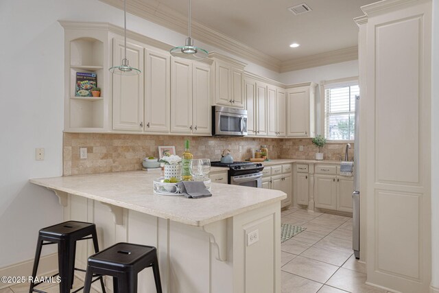 313 Summerland Key Ln, Lafayette, LA 70508 - kitchen with light countertops, a kitchen breakfast bar, stainless steel appliances, and a peninsula
