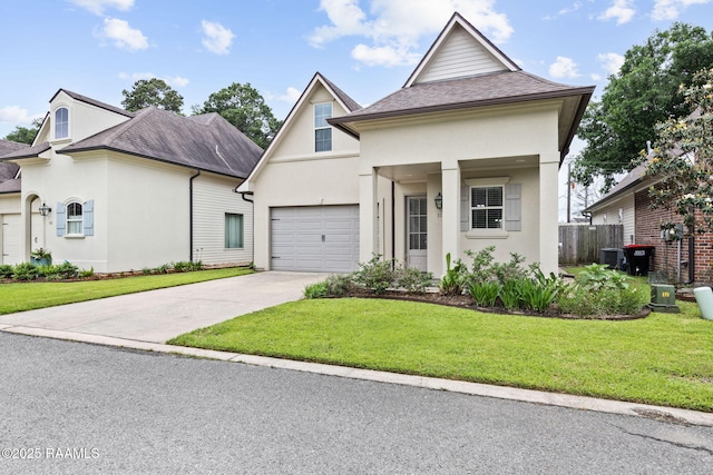 313 Summerland Key Ln, Lafayette, LA 70508 - view of front of property with concrete driveway, an attached garage, a front yard, and stucco siding