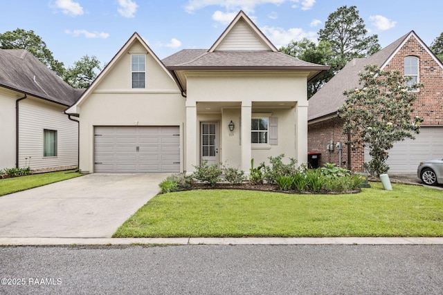 313 Summerland Key Ln, Lafayette, LA 70508 - view of front of house with roof with shingles, stucco siding, concrete driveway, and a front lawn
