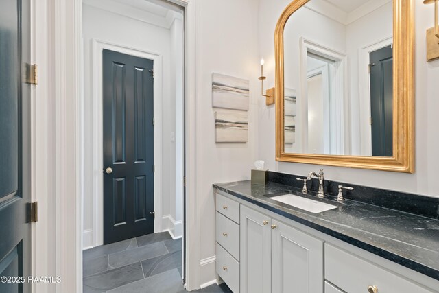 bathroom featuring baseboards and vanity