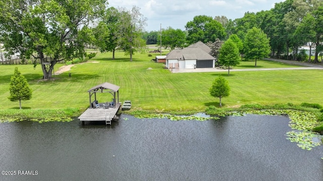 dock area featuring a lawn and a water view