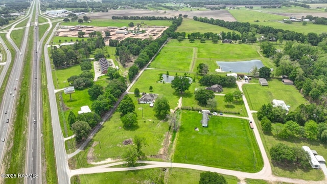 birds eye view of property with a rural view