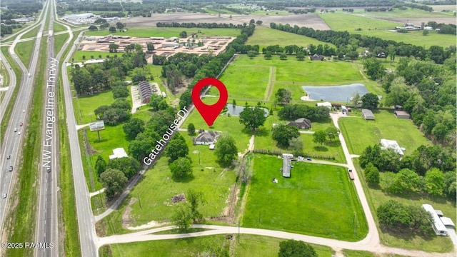 birds eye view of property featuring a rural view and a water view