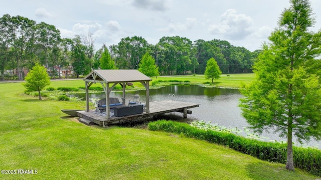 exterior space with a gazebo, a water view, a boat dock, and a yard