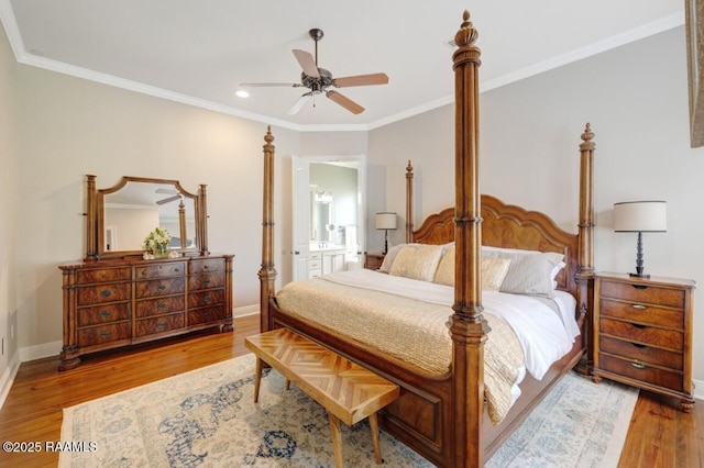 bedroom featuring crown molding, wood finished floors, and baseboards
