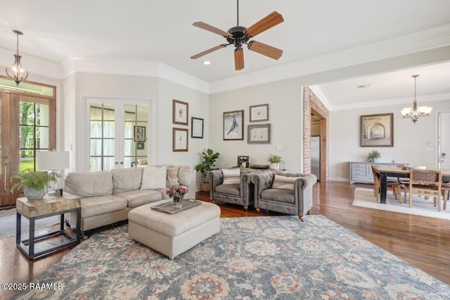 living area featuring french doors, recessed lighting, ceiling fan with notable chandelier, wood finished floors, and ornamental molding