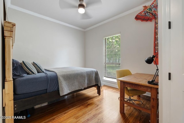 bedroom featuring wood finished floors, ceiling fan, and crown molding