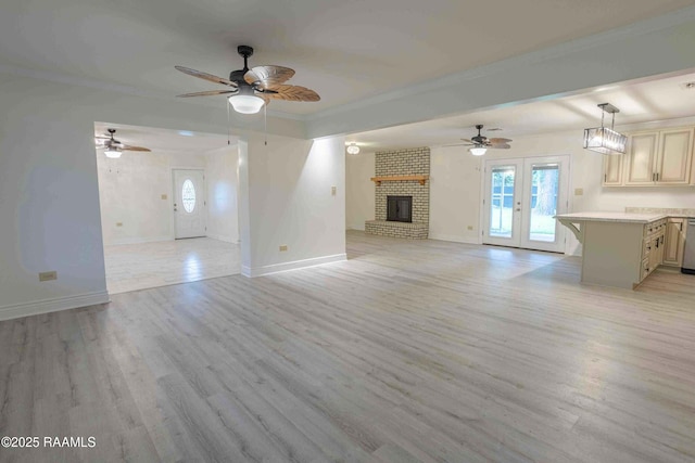 1706 Fuselier Rd, Arnaudville, LA 70512 - unfurnished living room featuring baseboards, light wood-type flooring, a ceiling fan, a brick fireplace, and crown molding