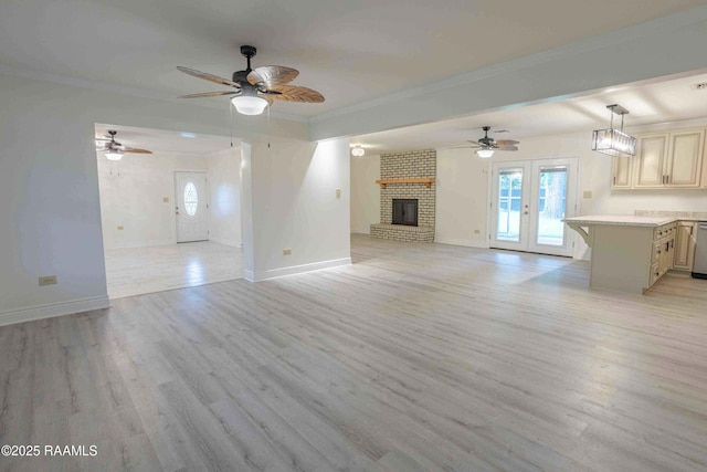 1706 Fuselier Rd, Arnaudville, LA 70512 - unfurnished living room with healthy amount of natural light, ornamental molding, baseboards, light wood-style floors, and a brick fireplace