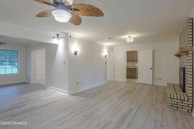1706 Fuselier Rd, Arnaudville, LA 70512 - unfurnished living room with ceiling fan, light wood finished floors, ornamental molding, a brick fireplace, and baseboards