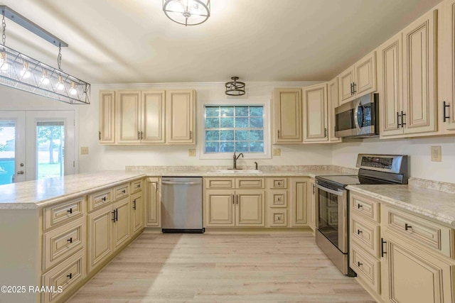 1706 Fuselier Rd, Arnaudville, LA 70512 - kitchen featuring stainless steel appliances, a sink, cream cabinetry, and a peninsula