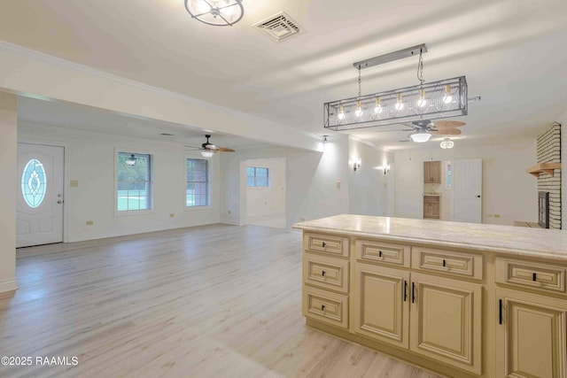 1706 Fuselier Rd, Arnaudville, LA 70512 - kitchen with cream cabinets, a ceiling fan, open floor plan, and light countertops
