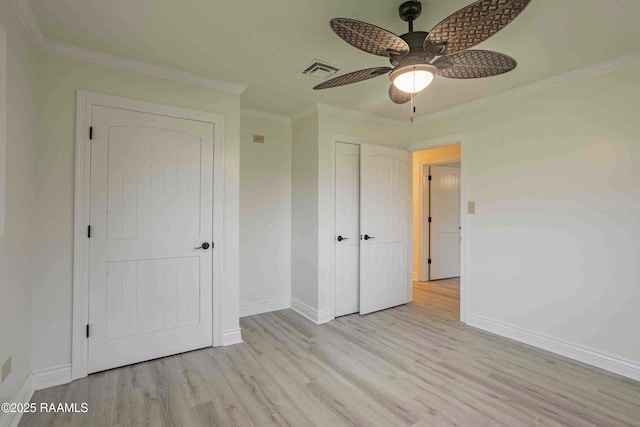 1706 Fuselier Rd, Arnaudville, LA 70512 - unfurnished bedroom featuring wood finished floors, baseboards, crown molding, a closet, and a ceiling fan