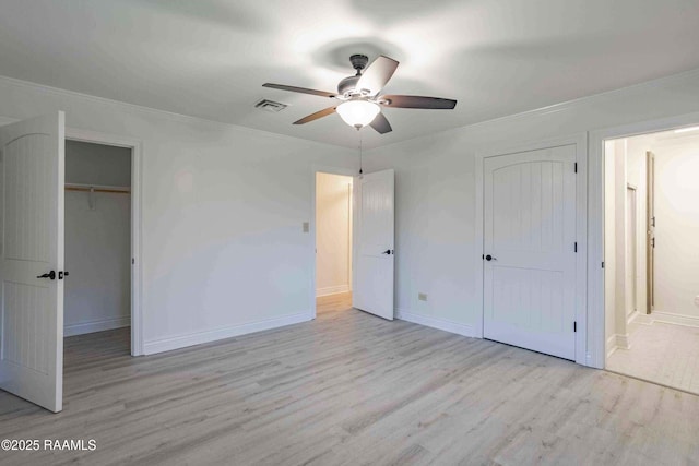 1706 Fuselier Rd, Arnaudville, LA 70512 - unfurnished bedroom with wood finished floors, ornamental molding, a closet, ensuite bathroom, and baseboards