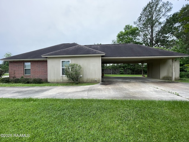 view of property exterior featuring a carport, a lawn, and concrete driveway