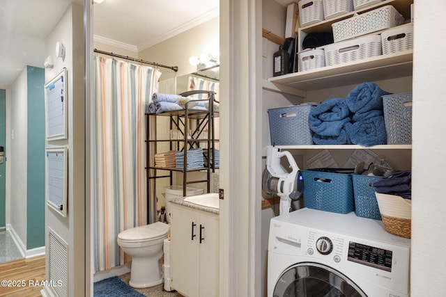 211 Versailles Blvd Unit 5, Lafayette, LA 70501 - laundry area featuring crown molding, visible vents, light wood-style floors, baseboards, and washer / clothes dryer