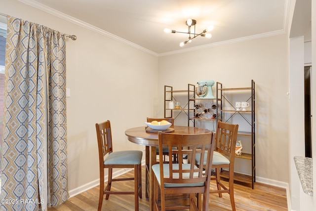 211 Versailles Blvd Unit 5, Lafayette, LA 70501 - dining room featuring crown molding, baseboards, a notable chandelier, and light wood-style flooring