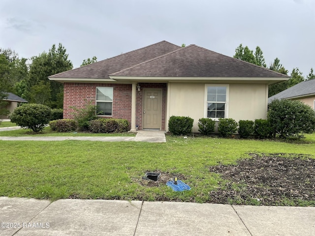 single story home featuring roof with shingles, a front lawn, and stucco siding