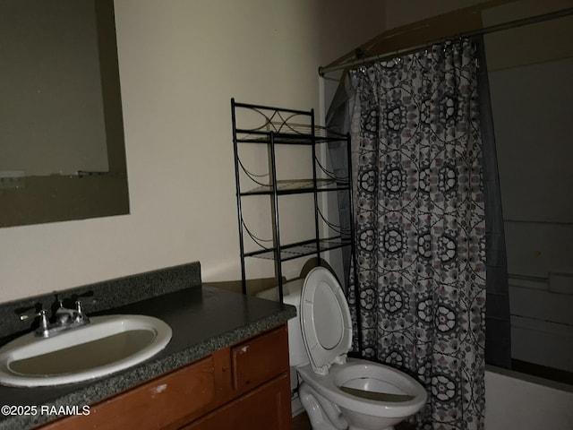 bathroom featuring shower / tub combo with curtain, toilet, and vanity