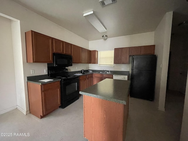 kitchen with a center island, a sink, dark countertops, visible vents, and black appliances