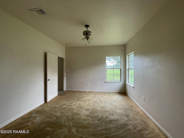 empty room featuring baseboards and visible vents