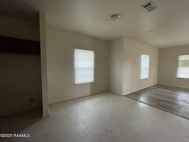 spare room with concrete floors and visible vents