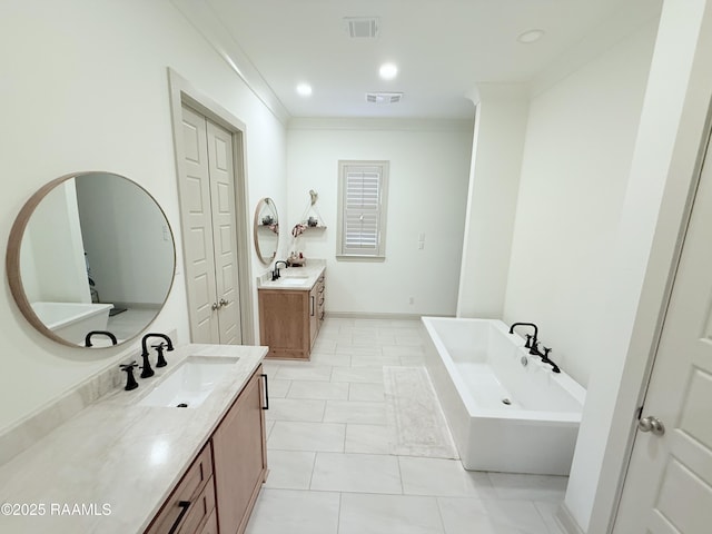 104 Cherrywood Dr, Lafayette, LA 70508 - bathroom with two vanities, a freestanding bath, crown molding, and recessed lighting