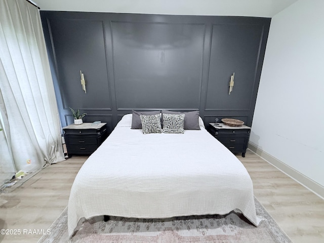 104 Cherrywood Dr, Lafayette, LA 70508 - bedroom with a decorative wall, light wood-style floors, and baseboards